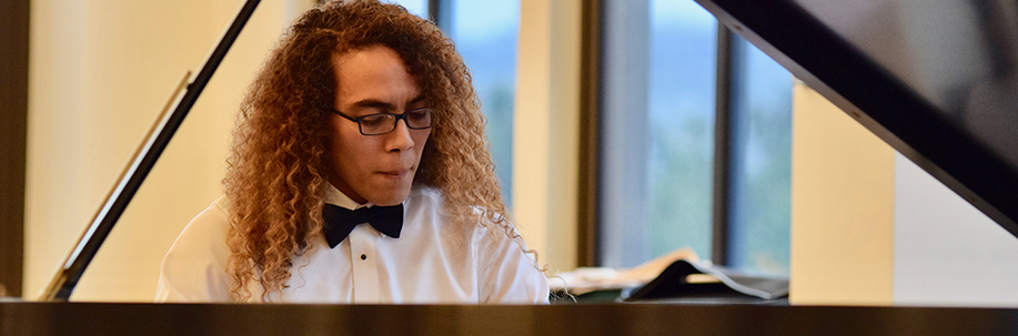 Photo of pianist playing on stage.