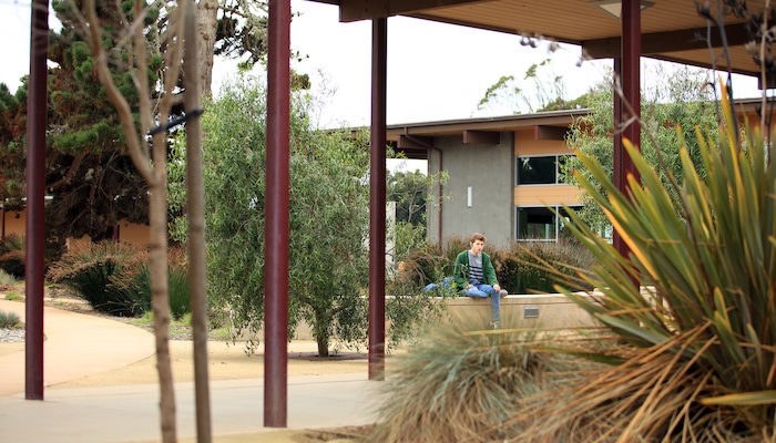 Student sitting outside Marina campus