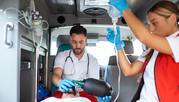 Male paramedic works with patient