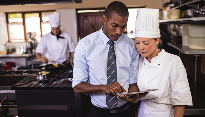 Restaurant manager goes over the menu with the head chef