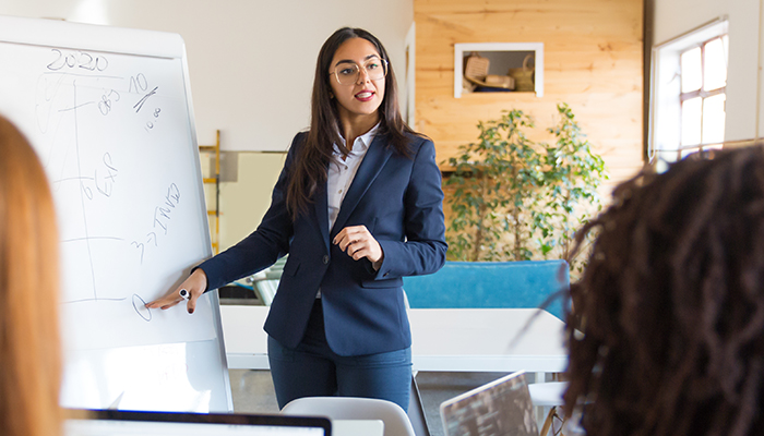 Manager presents ideas to staff during business meeting