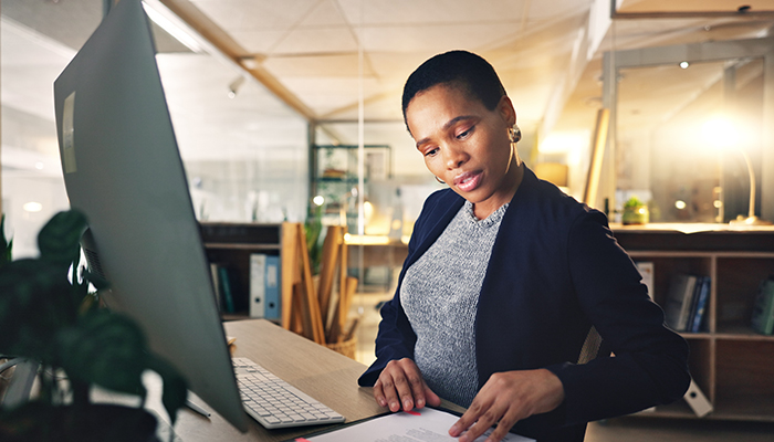 Business professional works on notes in company office