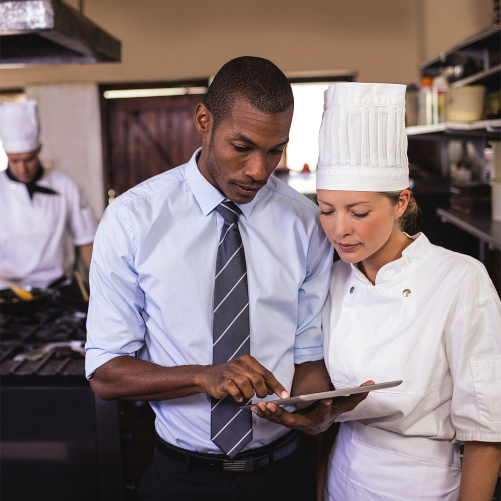 Restaurant manager sharing insights with kitchen staff