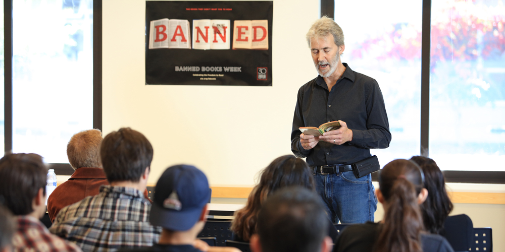 Hnery Marchand reads an excerpt from a banned book during MPC's Banned Bookd Read Out