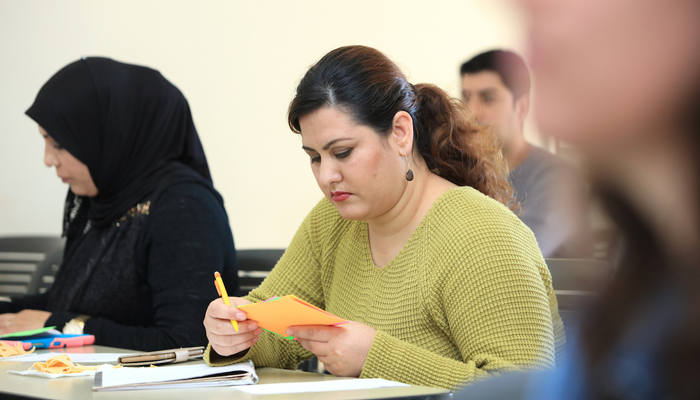 ESL student studies notecard during class