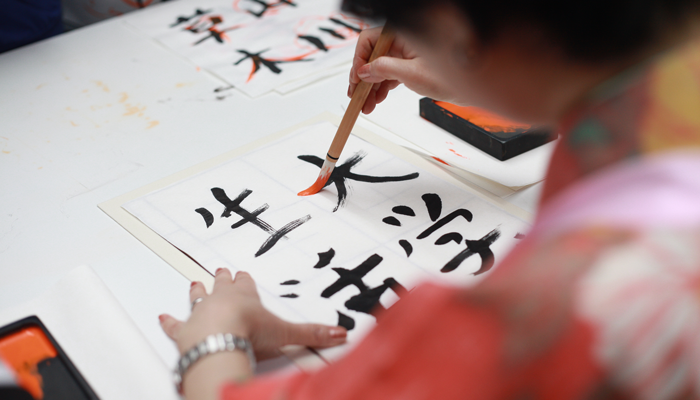 Student learning to write Kanji