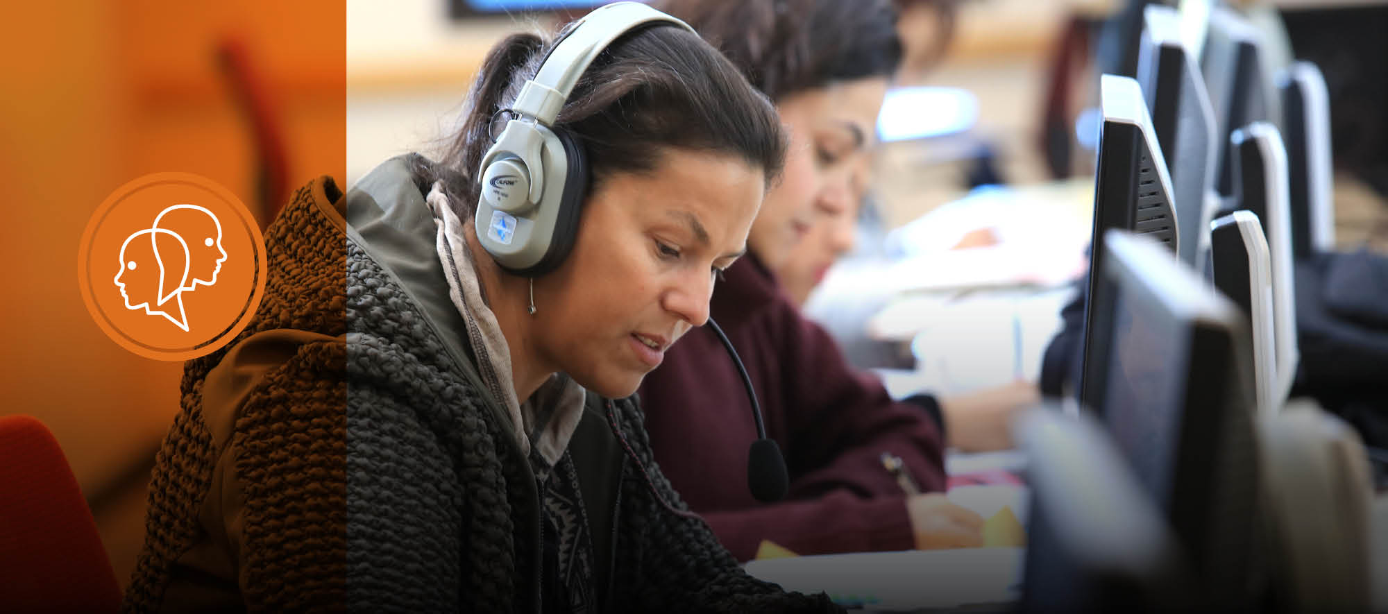 ESL student using a computer to develop listening skills during lab time