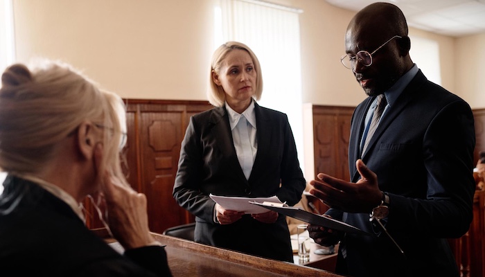 Two Lawyers Speaking with Judge Inside Courthouse