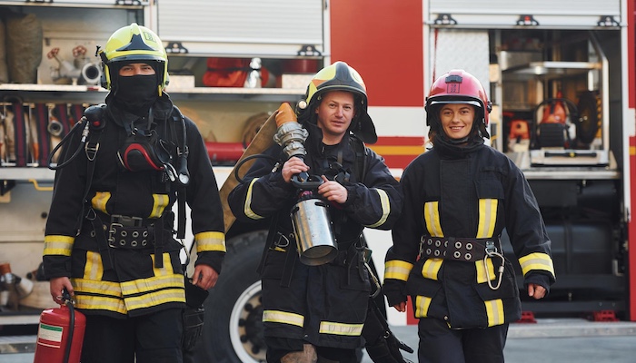 Three Firefighters in Uniform Undergoing Training