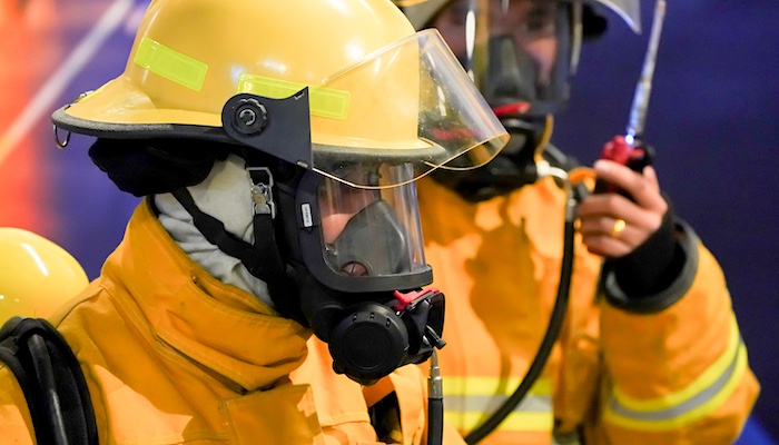 Two Firefighters in Uniform Undergoing Training