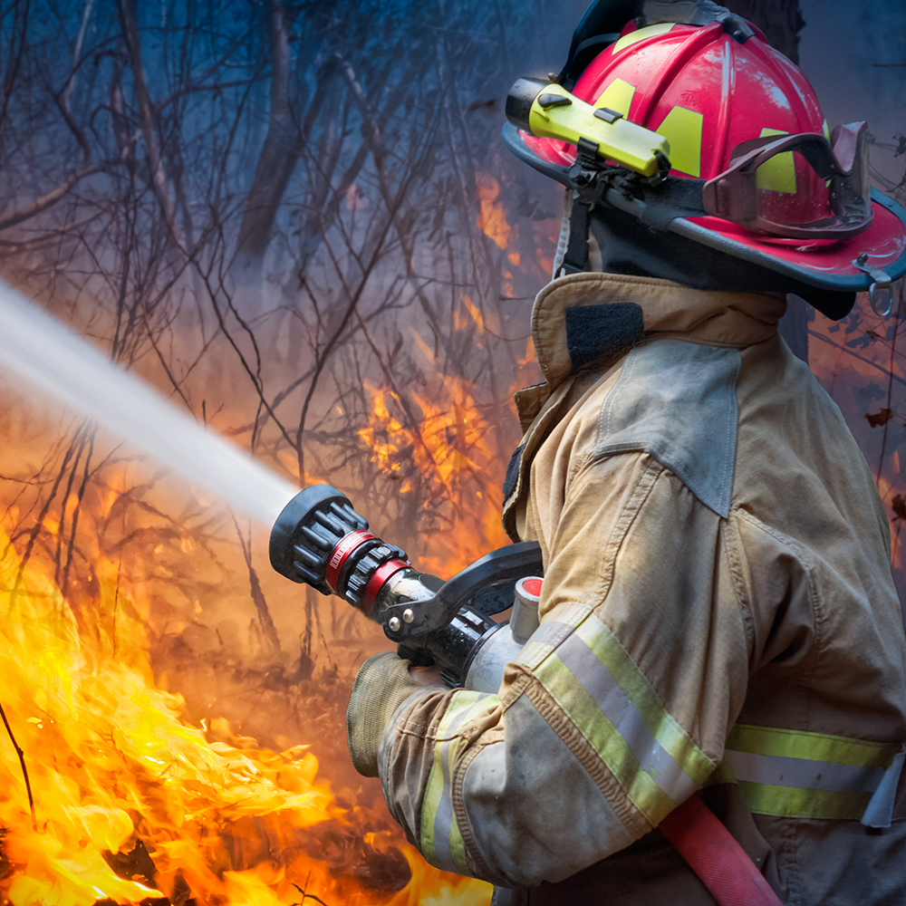 Firefighter working to control a wildfire