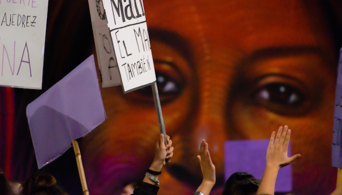 People Holding up Hands and Signs at Protest