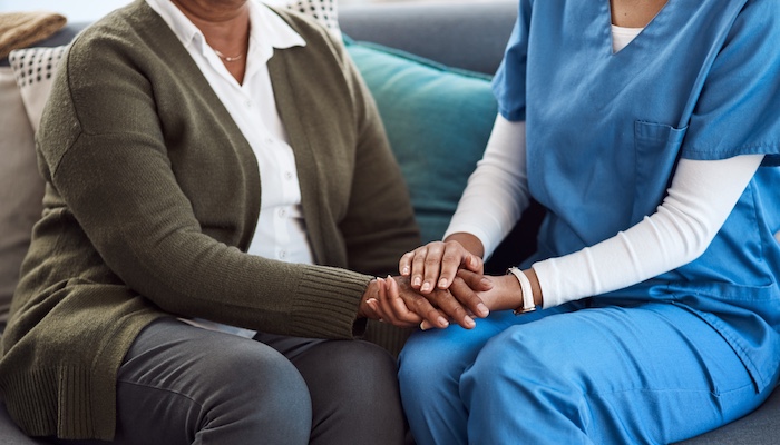 Social Worker Holding Hands of Patient