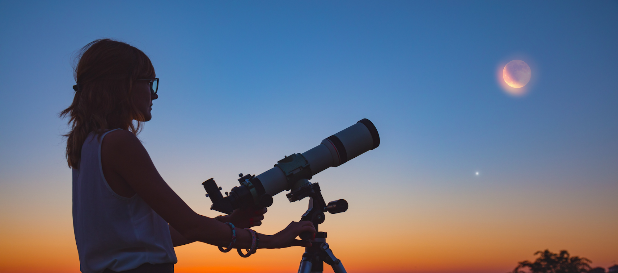 Person Looking at Moon with a Telescope