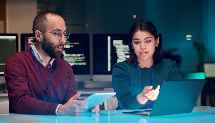 Two Computer Scientists Viewing Laptop Together