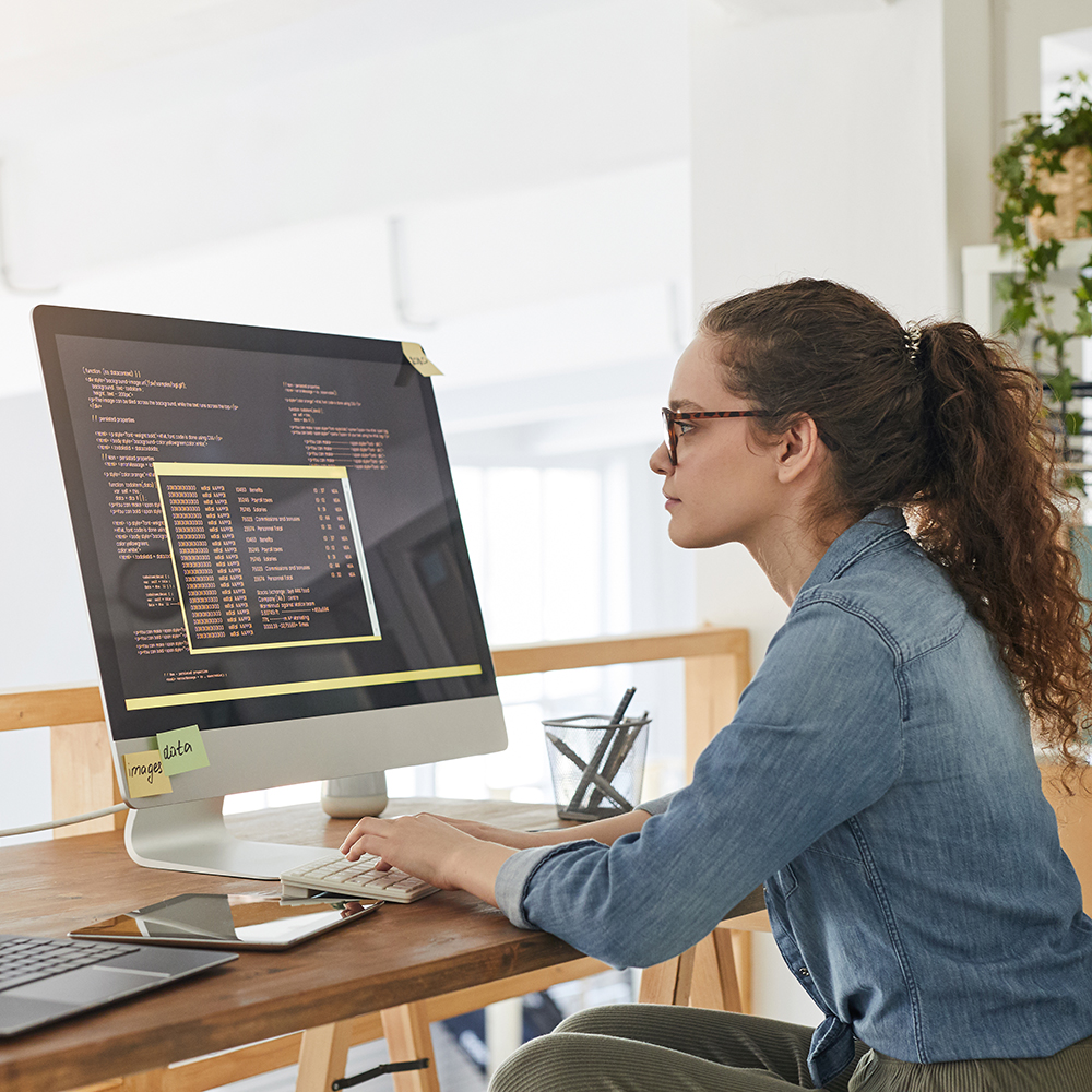 Programmer writes code on a computer at home