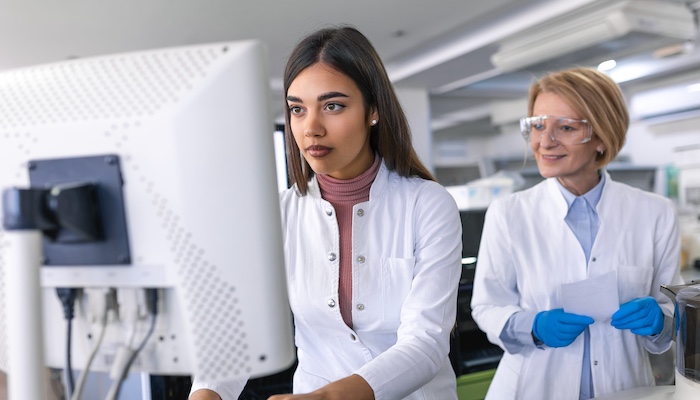 Two Physicists Viewing Computer Together