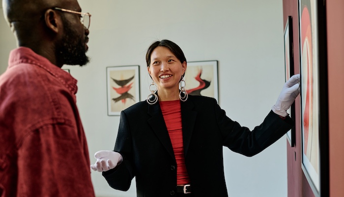 Art Historian Explaining Art Piece in Art Gallery