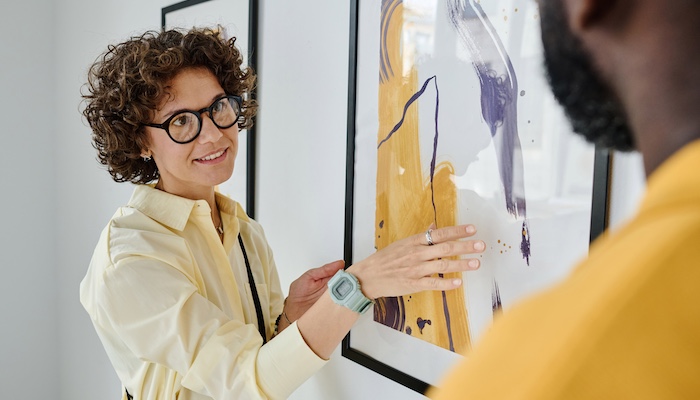 Art Historian Talking to Visitor in Art Gallery