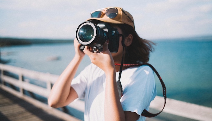 Person Taking Picture with Digital Camera at Ocean