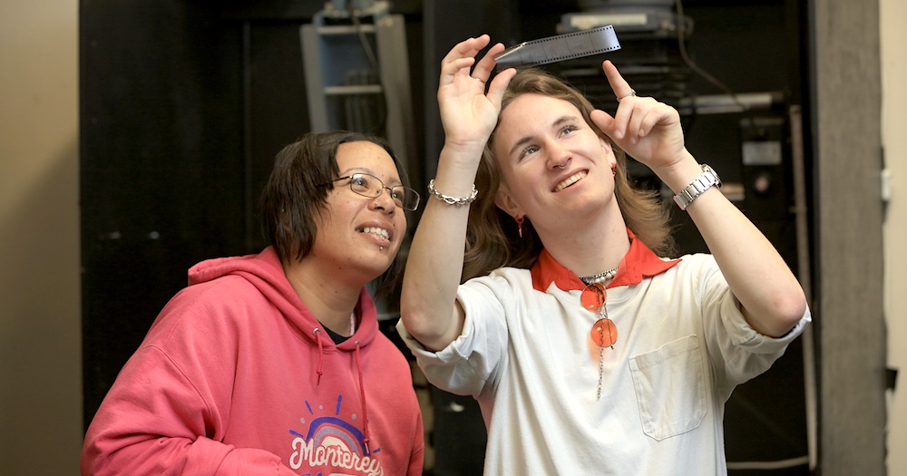 Photography students examining print