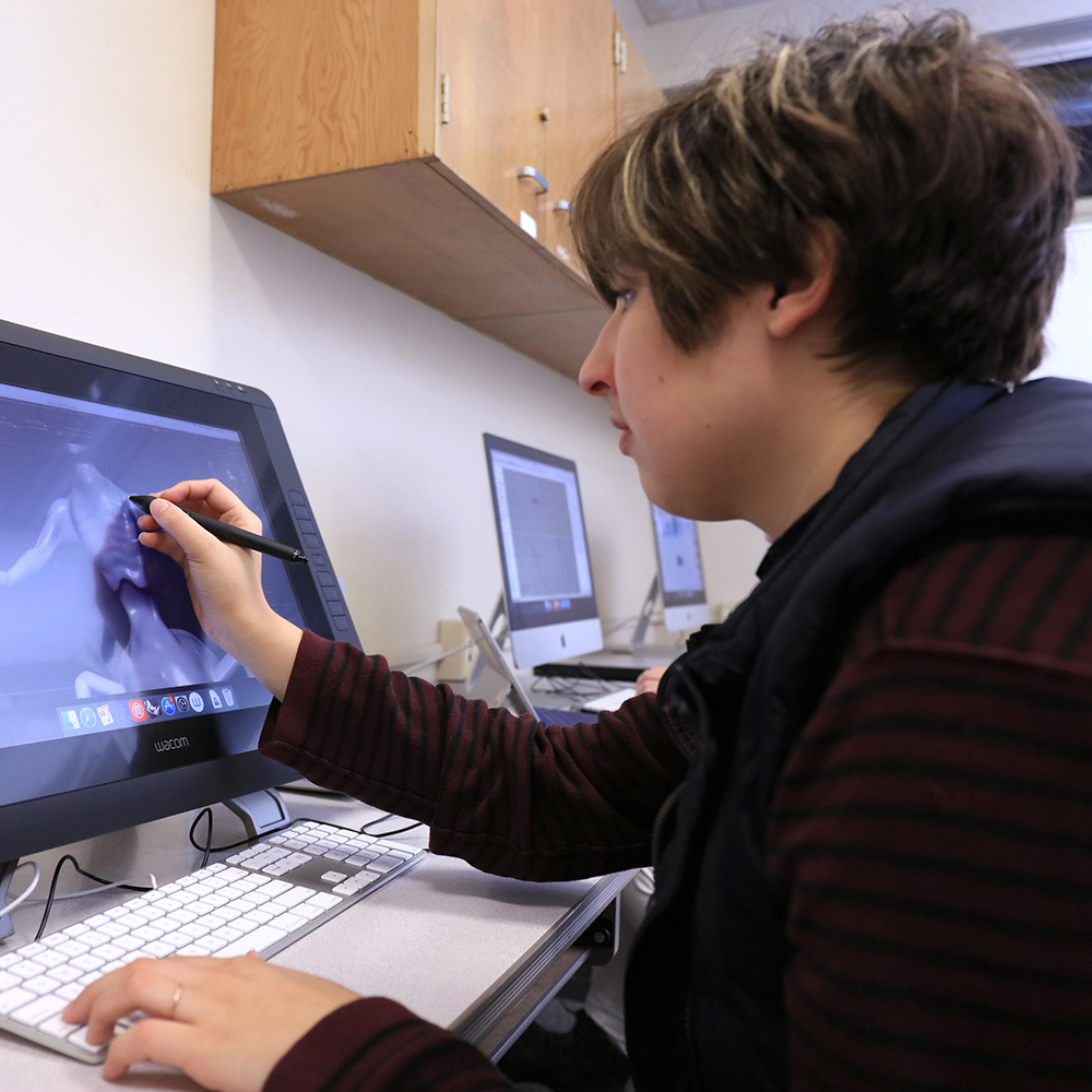 MPC Student works on design project on the computer