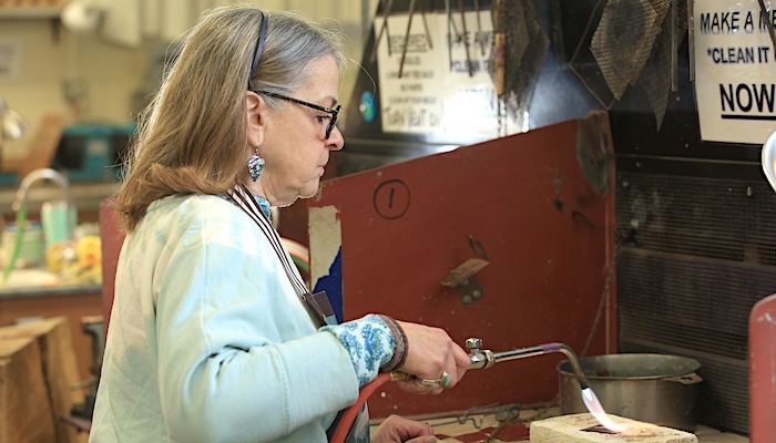 Jewelry & Metal Arts Student Using Blowtorch in Class