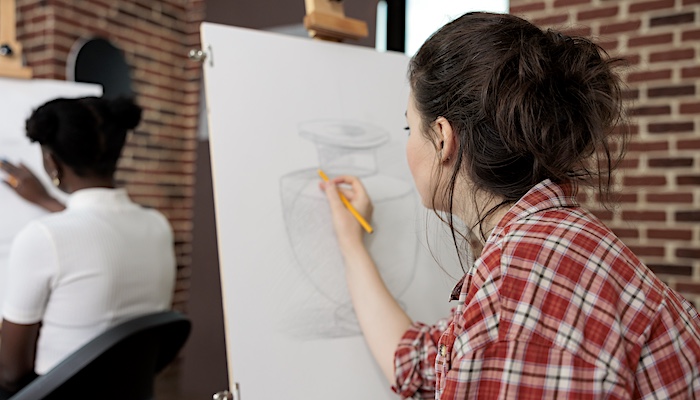 Woman Drawing Vase on Easel