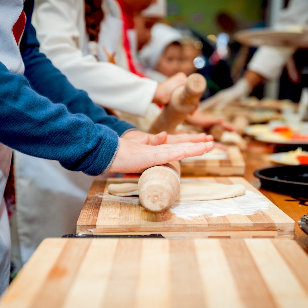 Culinary Class Students Rolling Out Dough with Rolling Pin