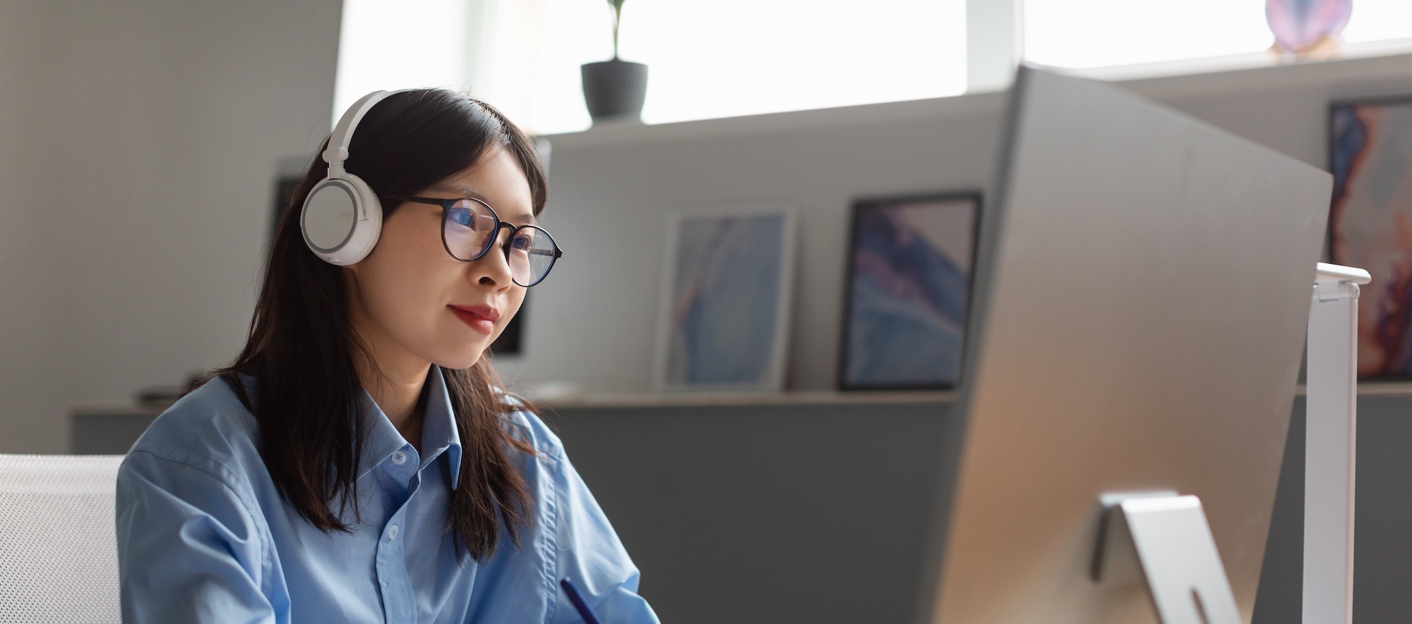 Woman Working on Laptop with Headphones on