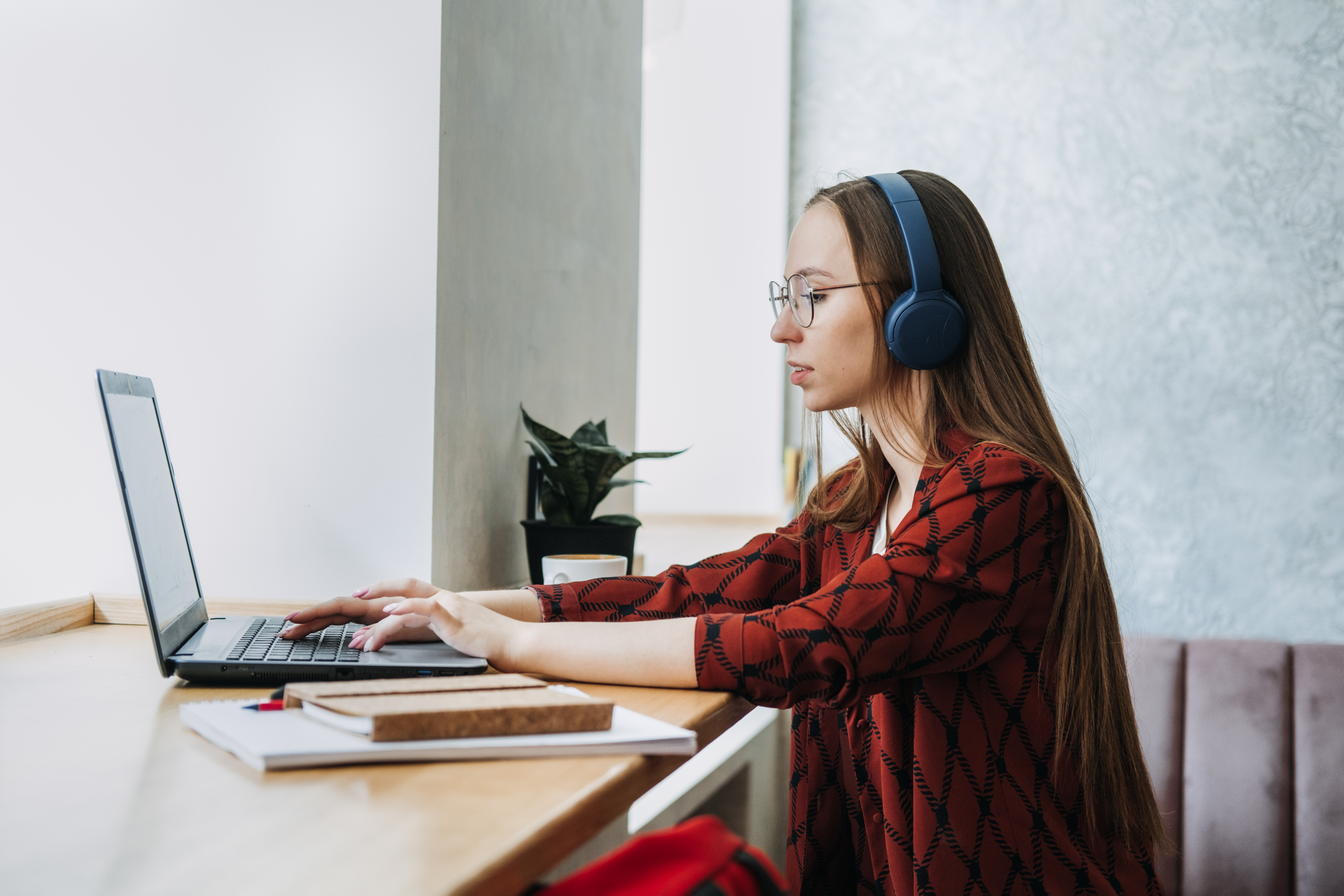 A Woman with Headphones on Working on Computer