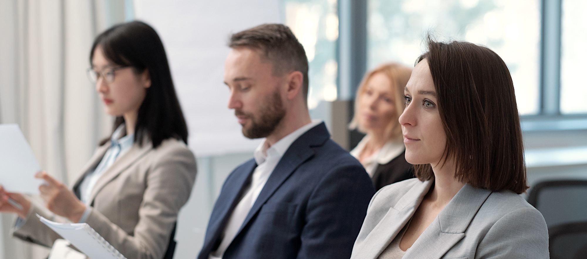 Three People in Professional Clothing Listening