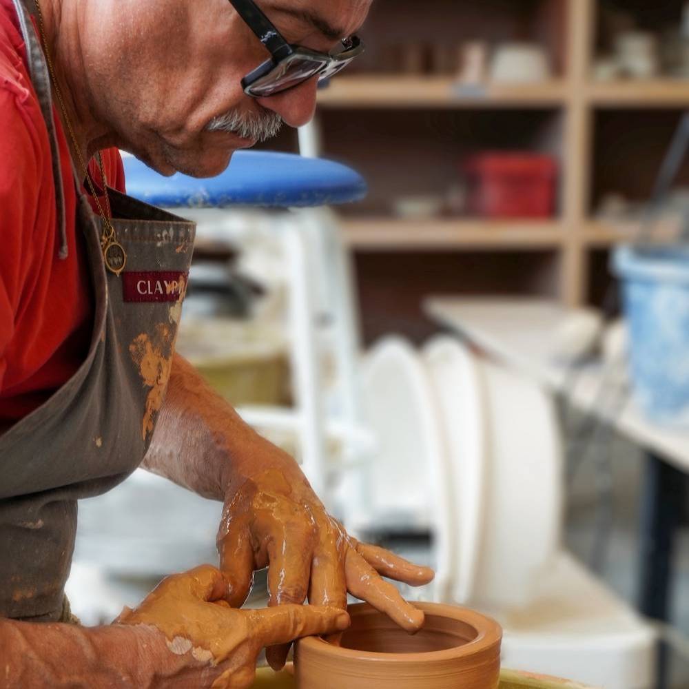 MPC Ceramics Student Throwing on Wheel in Class