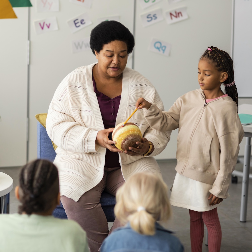 Elementary School Teacher Teaching Music to Students