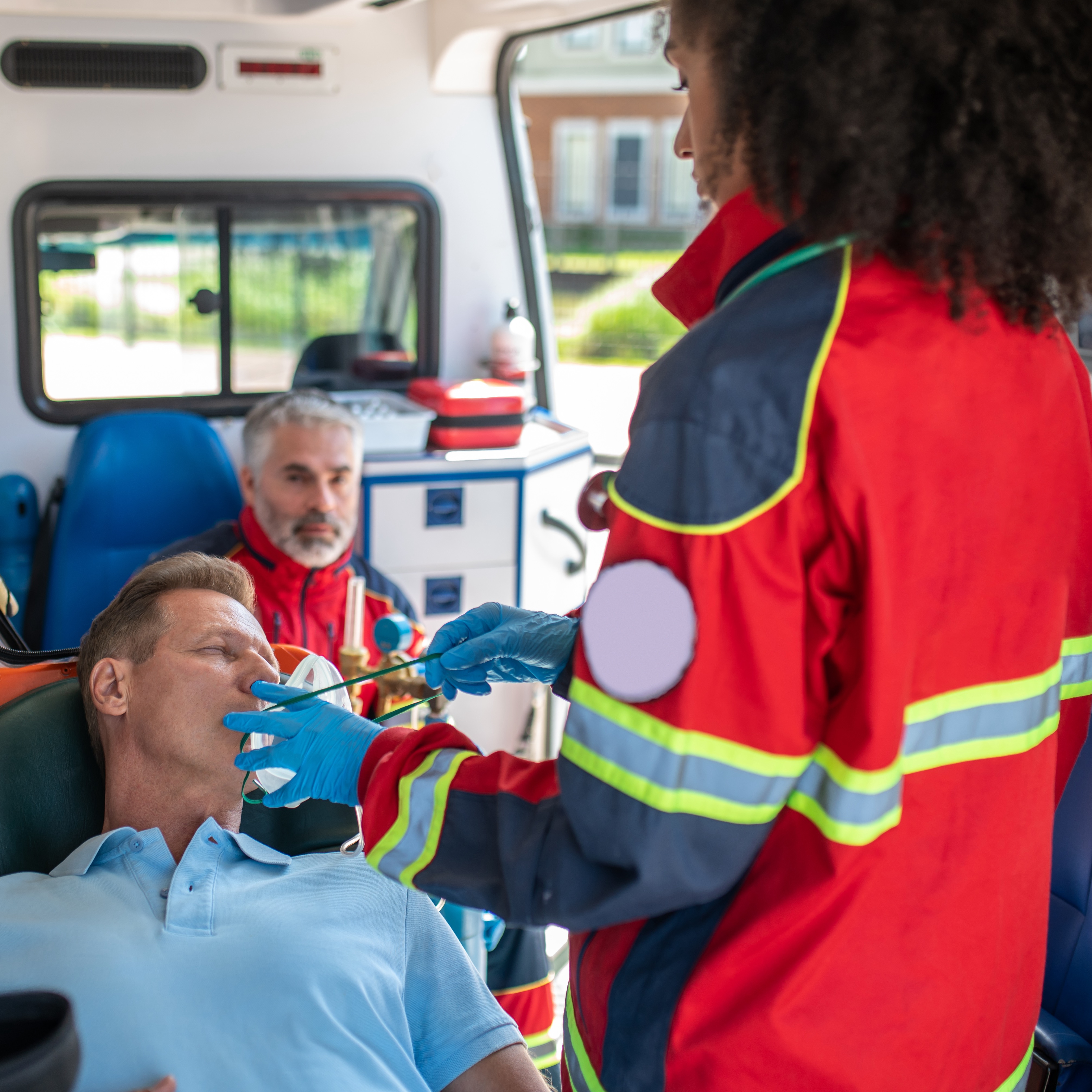 EMT in Ambulance Helping Patient