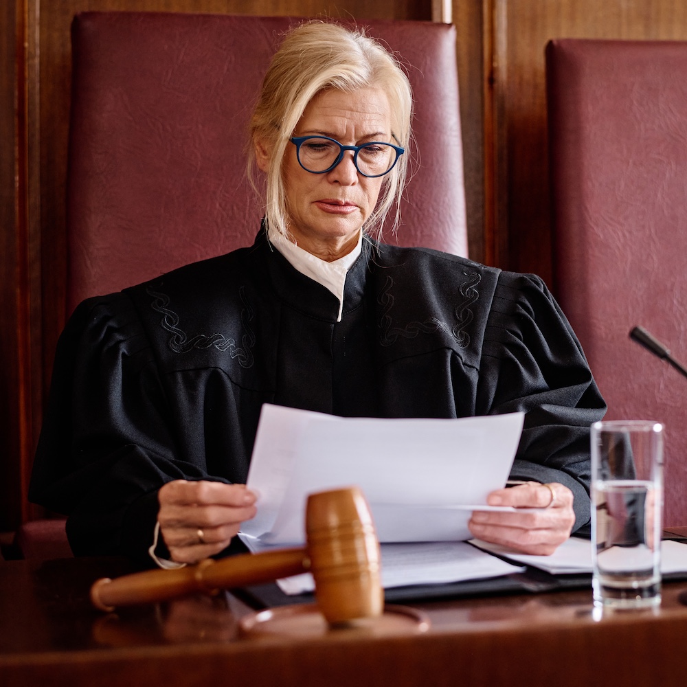 Judge Looking at Papers at Podium