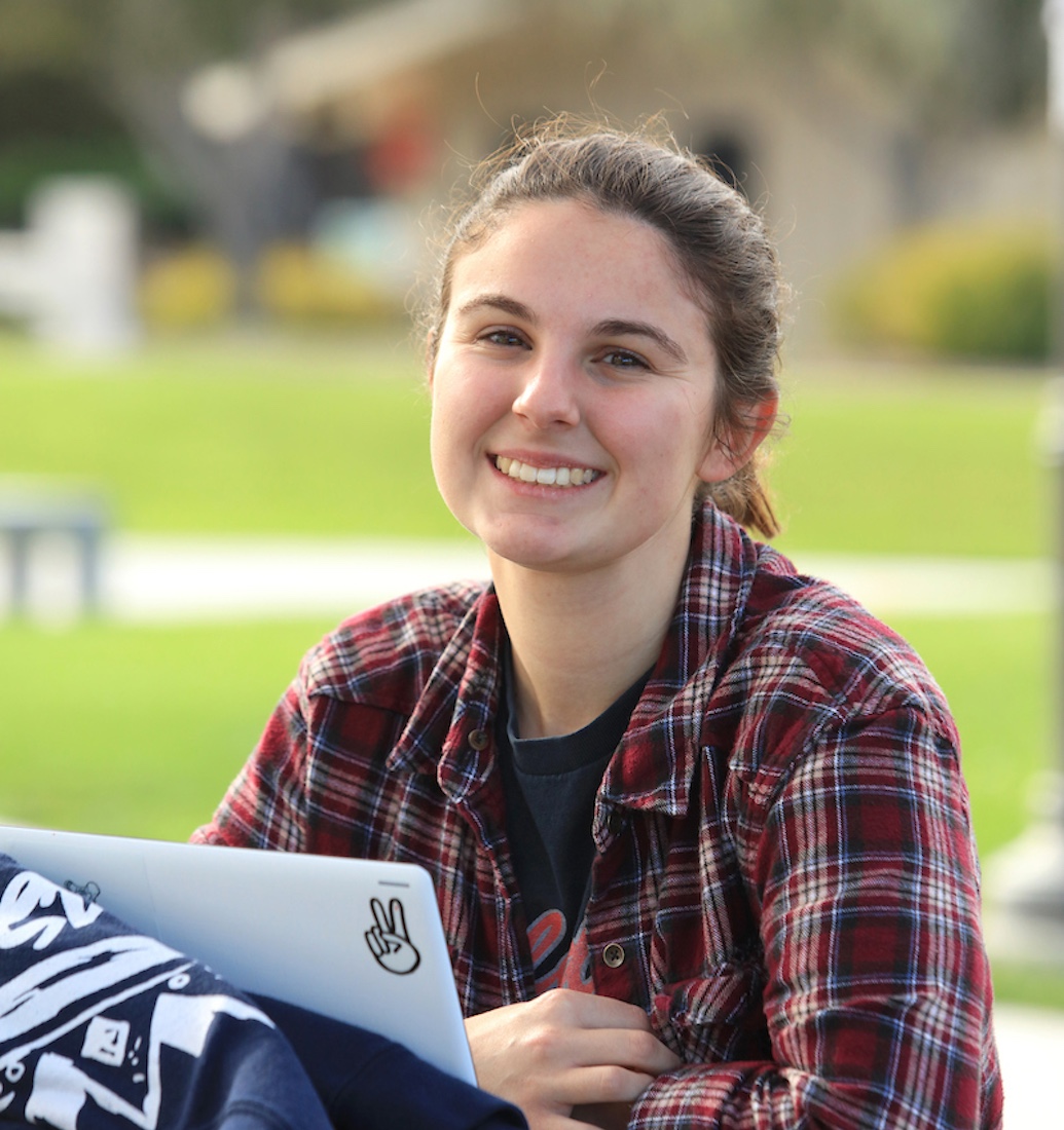 Student smiling with laptop