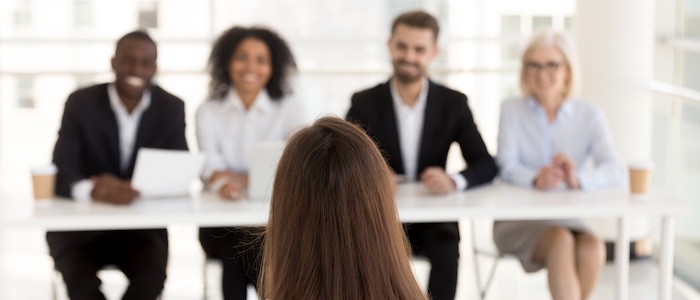 Person Sitting in Front of Group of Interviewers