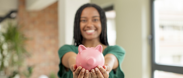 Woman Holding Up Piggy Bank