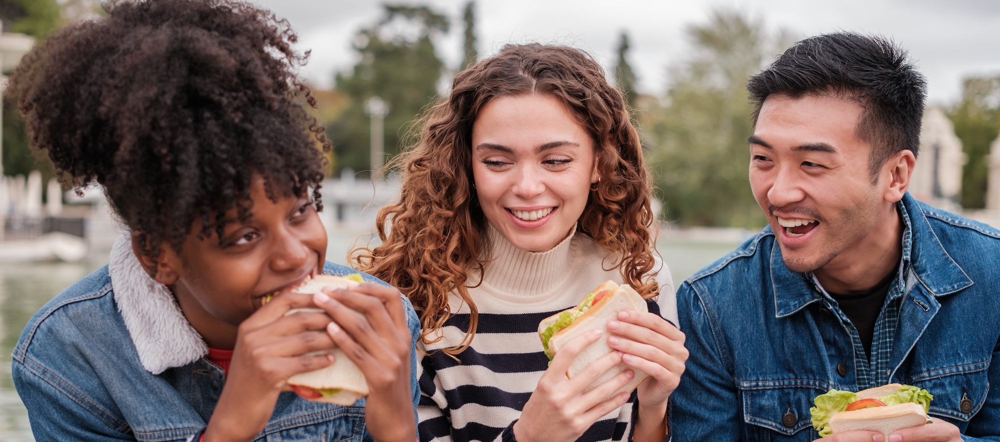 Student at Student Cafeteria Holding Salad and Giving a Thumbs Up