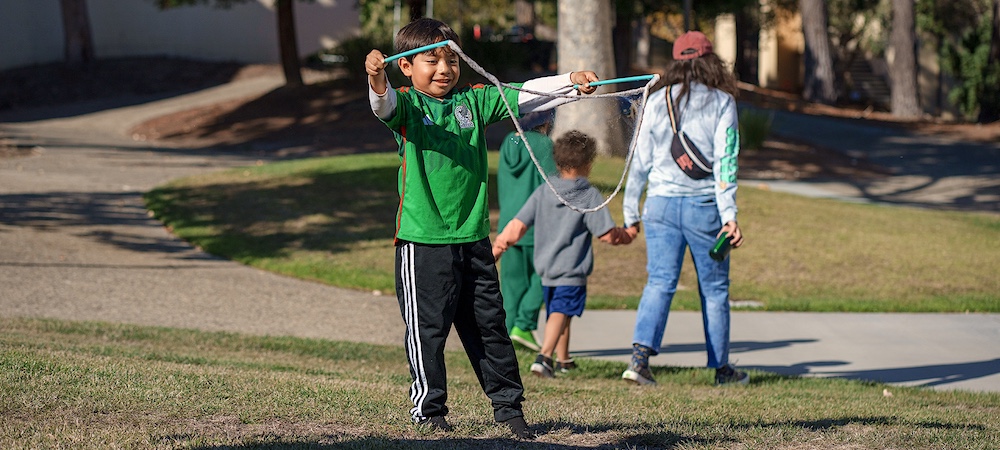 Child Blowing Bubbles at Family STEM Day