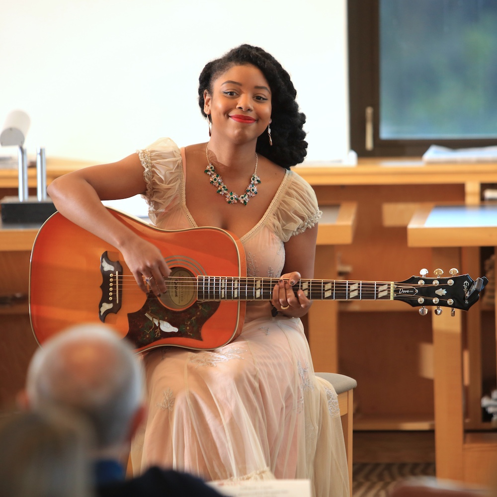 Student Playing Guitar in MPC Library for Music in the Stacks Performance