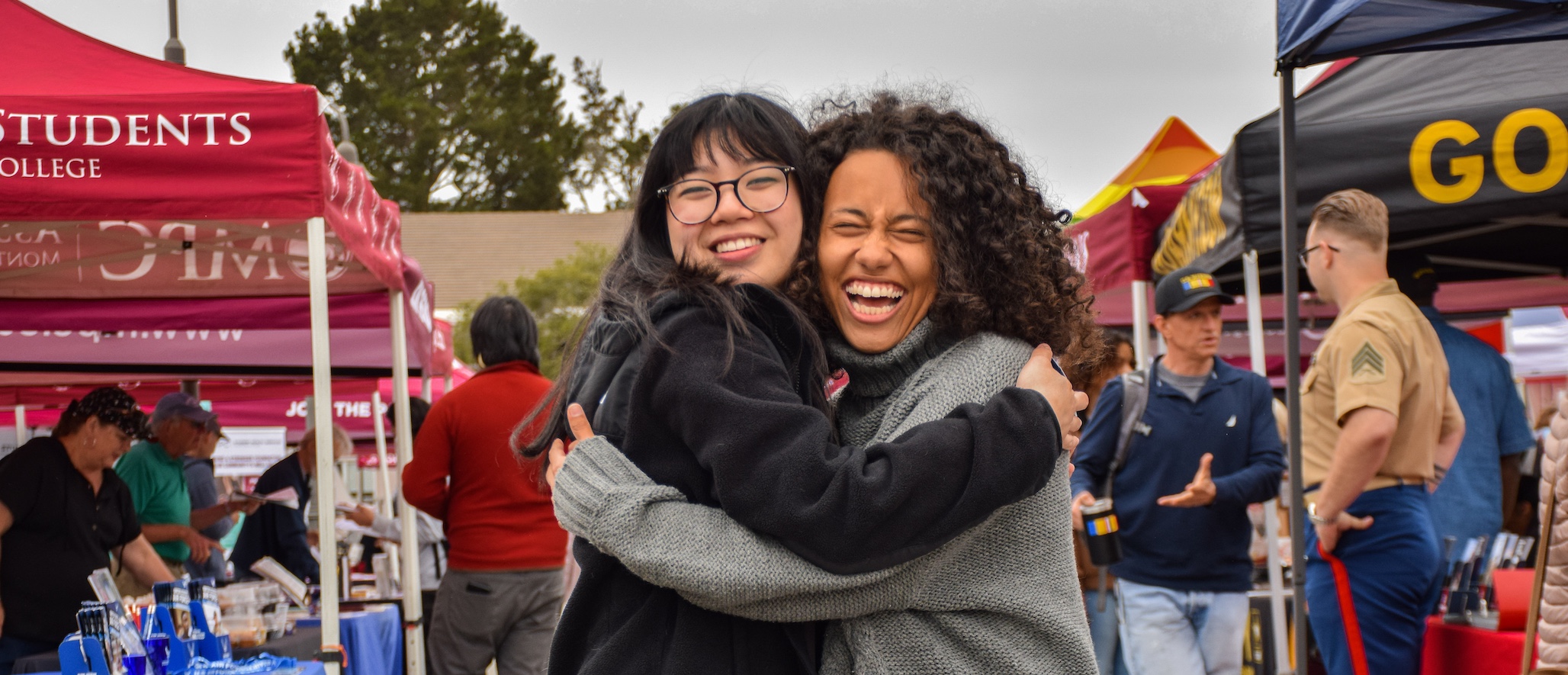 Two Students Smiling & Hugging Each Other at Campus Lobo Day