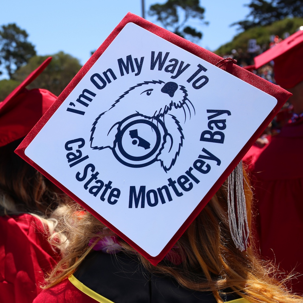 Student with Grad Cap Decorated with "I'm on my way to Cal State Monterey Bay"