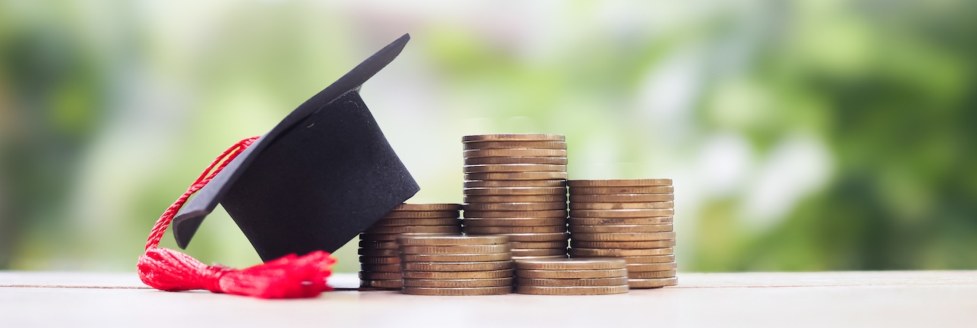 Graduation Cap on Top of Coins