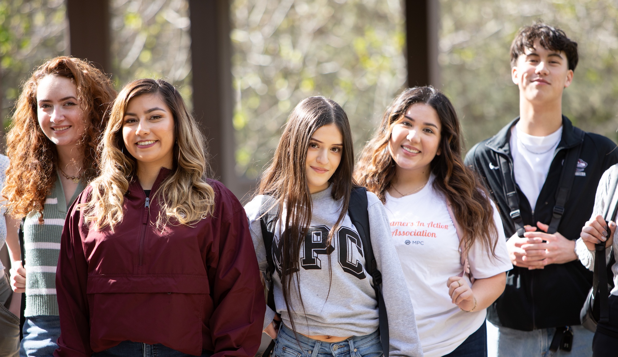 mpc students working on computer together outside