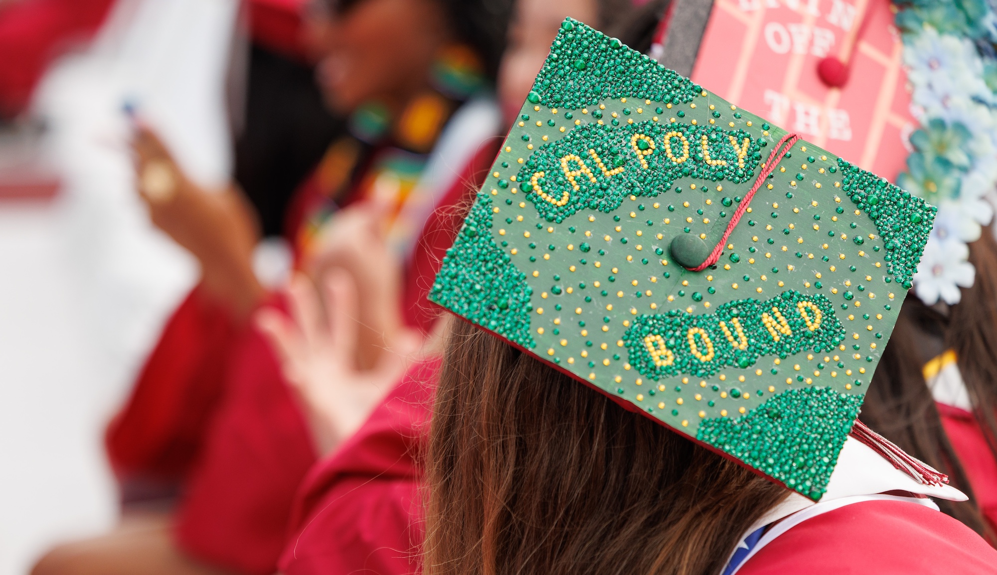 mpc graduate with cal poly bound message bejeweled on her cap