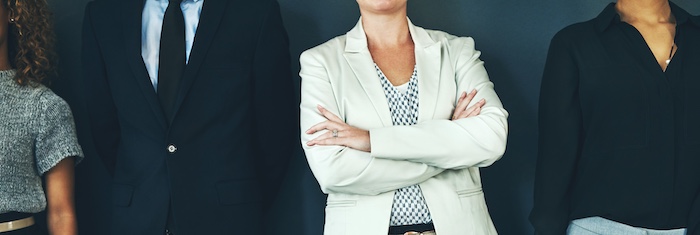 business people in suits and ties posing with each other