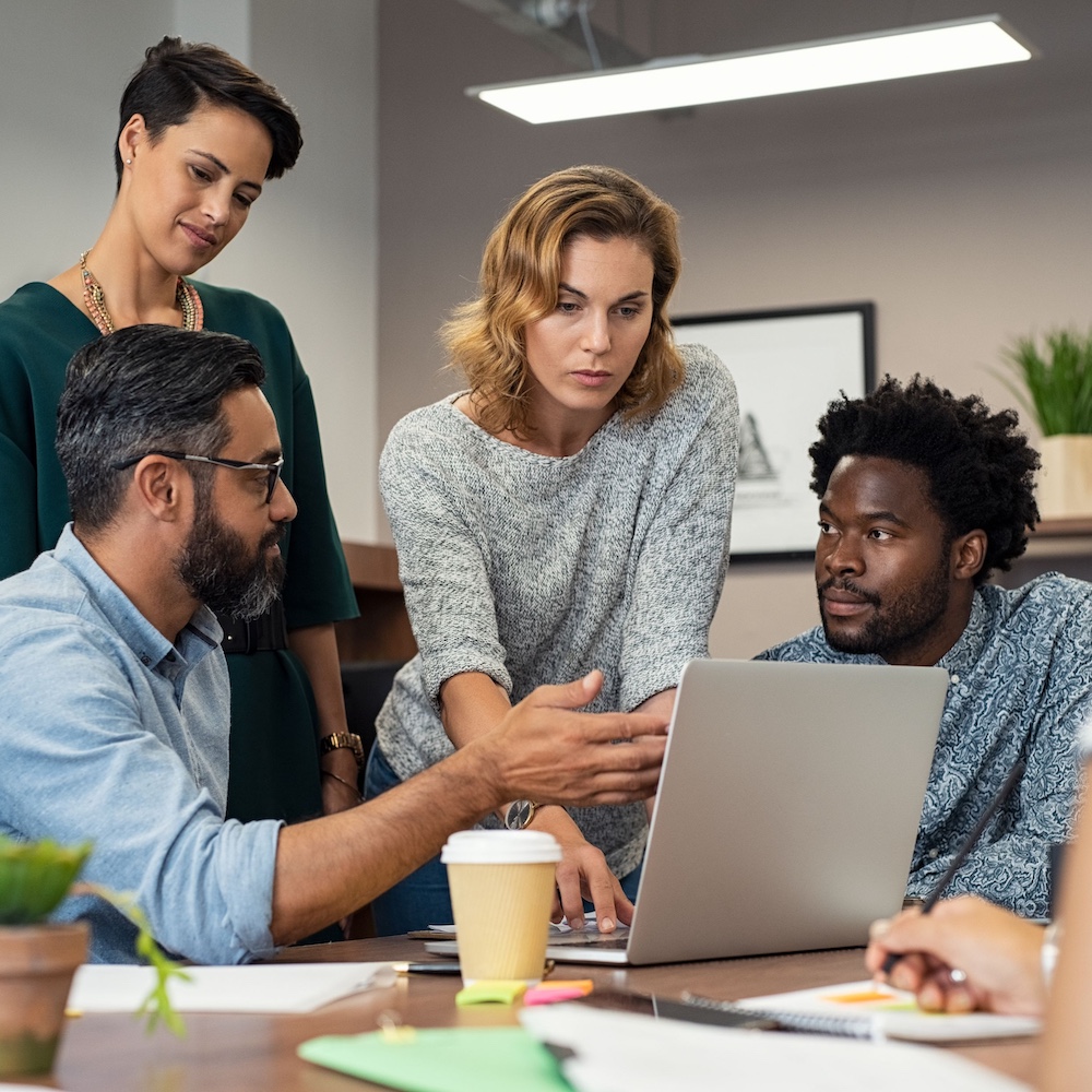 Coworkers Having Team Discussion Around Laptop