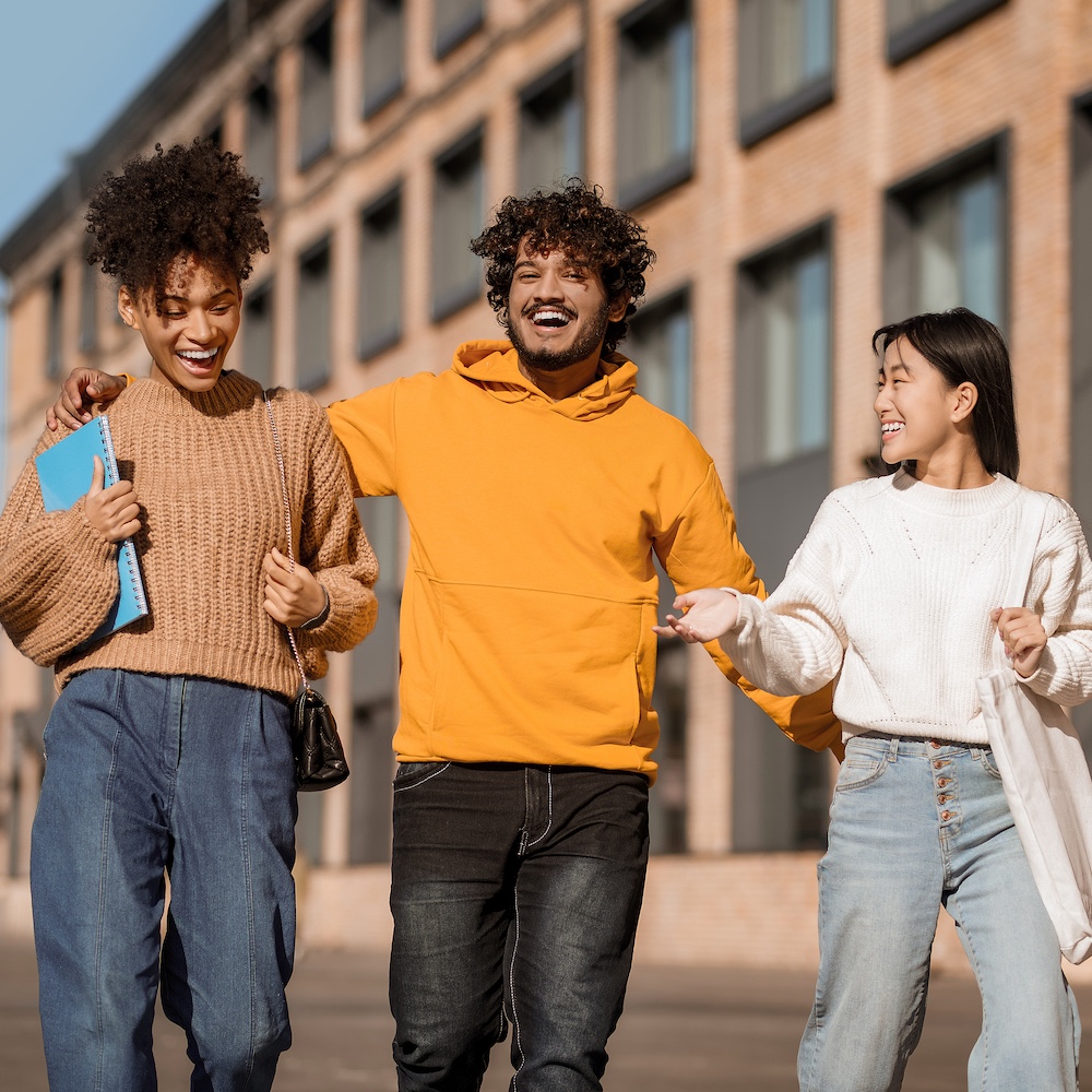 College Students Laughing and Walking Together Outside